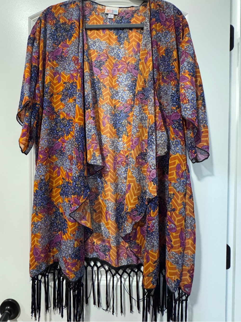 LuLaRoe Monroe Kimono Orange background with Floral print & black fringe.